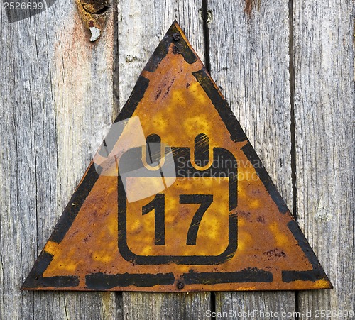 Image of Calendar with Date Icon on Rusty Warning Sign.