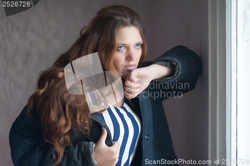 Image of Sad woman near window