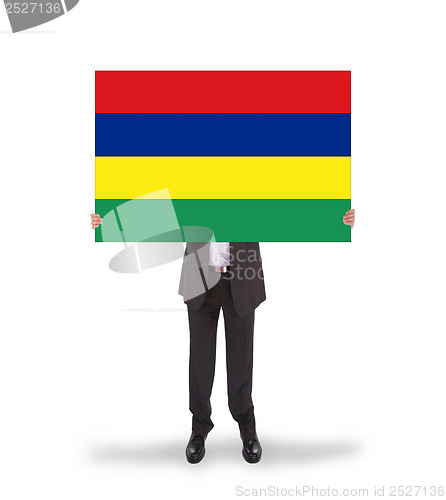 Image of Businessman holding a big card