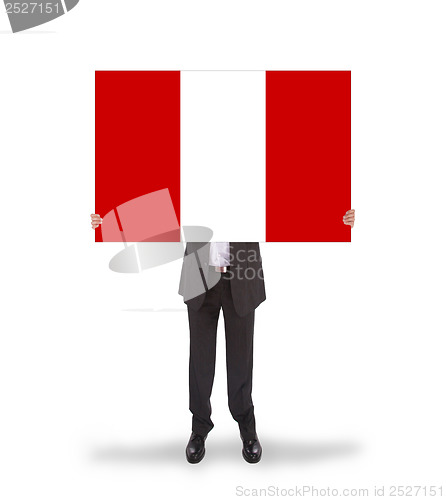 Image of Businessman holding a big card