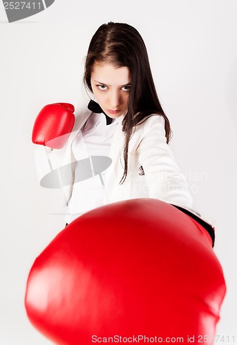 Image of young businesswoman in boxing gloves