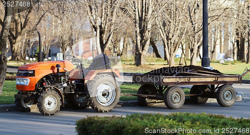 Image of Orange tractor with a trailer park