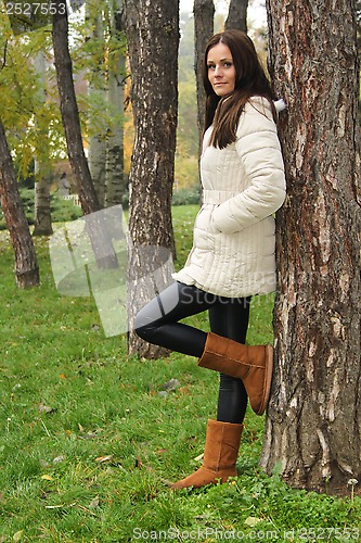 Image of Lady leaning on tree