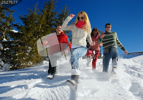 Image of friends have fun at winter on fresh snow