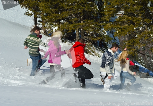 Image of friends have fun at winter on fresh snow