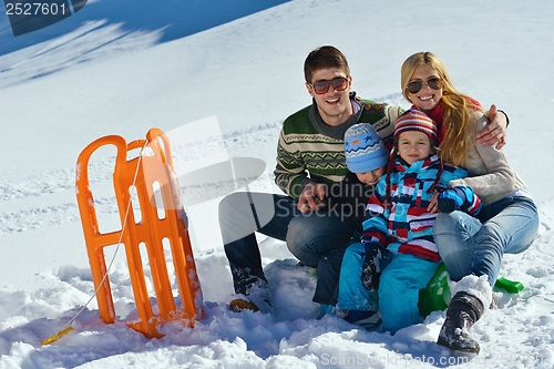 Image of family having fun on fresh snow at winter vacation