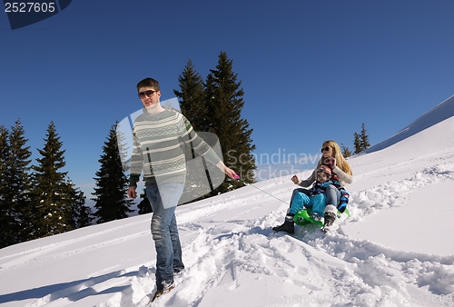 Image of family having fun on fresh snow at winter vacation