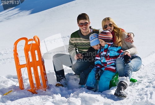Image of family having fun on fresh snow at winter vacation