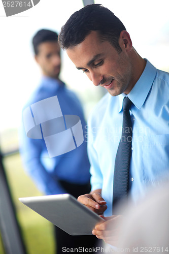 Image of business man using tablet compuer at office