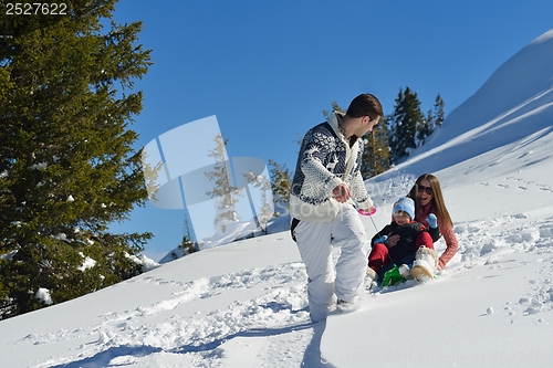 Image of family having fun on fresh snow at winter vacation