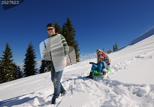 Image of family having fun on fresh snow at winter vacation