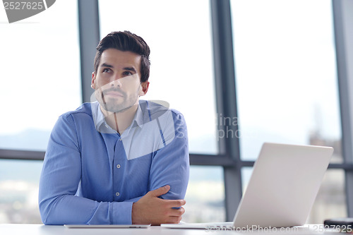 Image of happy young business man at office