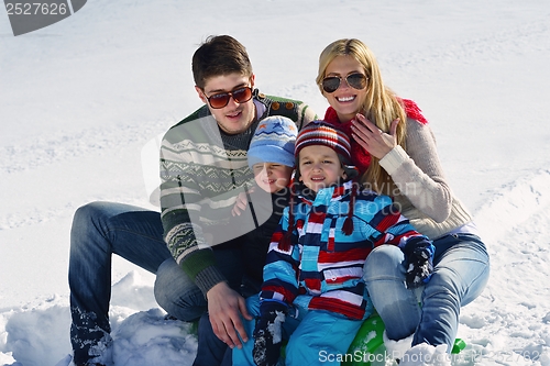 Image of family having fun on fresh snow at winter vacation