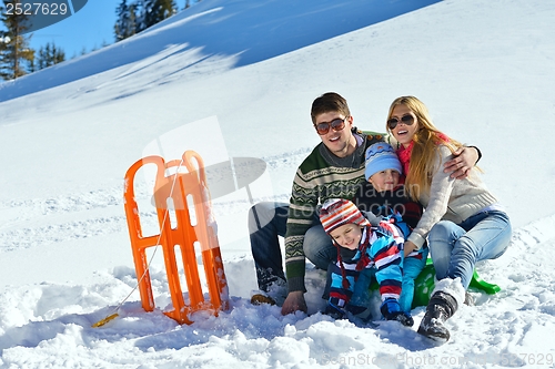 Image of family having fun on fresh snow at winter vacation