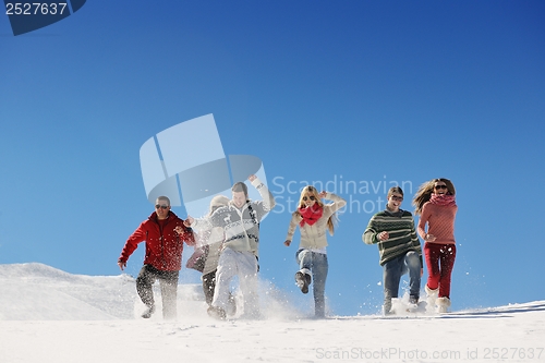 Image of friends have fun at winter on fresh snow