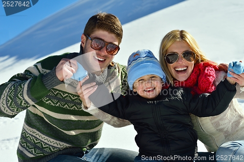 Image of family having fun on fresh snow at winter vacation