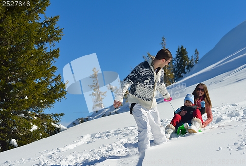 Image of family having fun on fresh snow at winter vacation