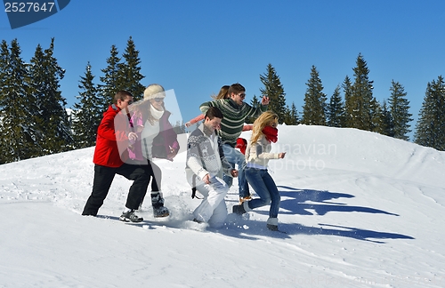 Image of friends have fun at winter on fresh snow