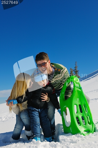 Image of family having fun on fresh snow at winter vacation