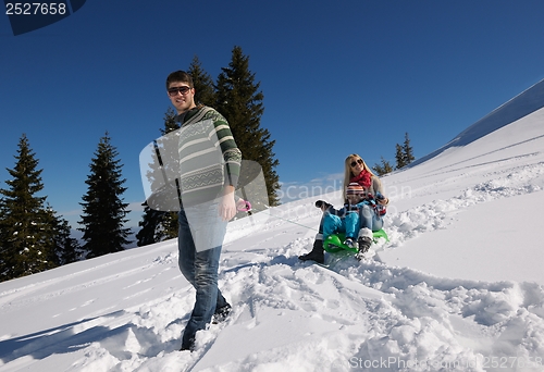 Image of family having fun on fresh snow at winter vacation