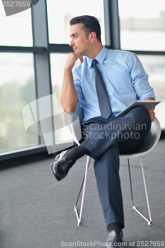 Image of happy young business man at office
