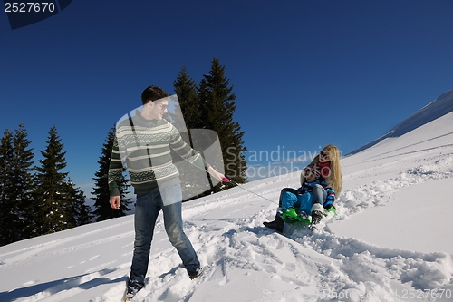 Image of family having fun on fresh snow at winter vacation