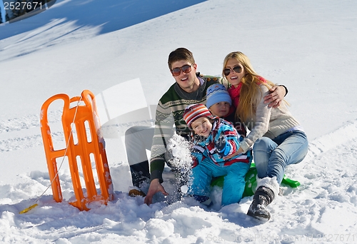 Image of family having fun on fresh snow at winter vacation