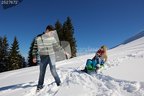 Image of family having fun on fresh snow at winter vacation