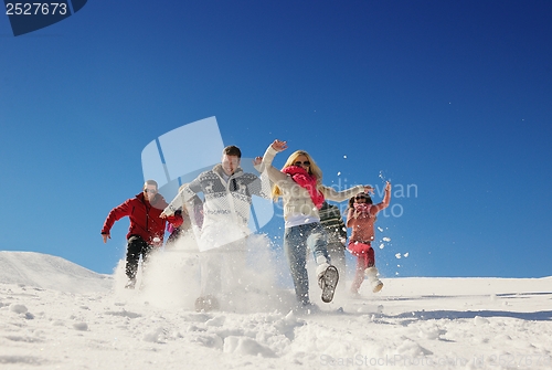 Image of friends have fun at winter on fresh snow