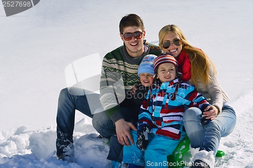 Image of family having fun on fresh snow at winter vacation