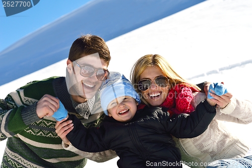 Image of family having fun on fresh snow at winter vacation