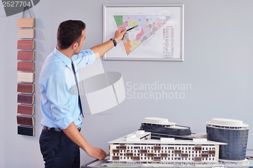 Image of business man waiting for meeting to begin in Board room