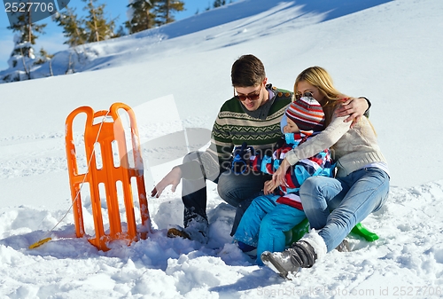 Image of family having fun on fresh snow at winter vacation
