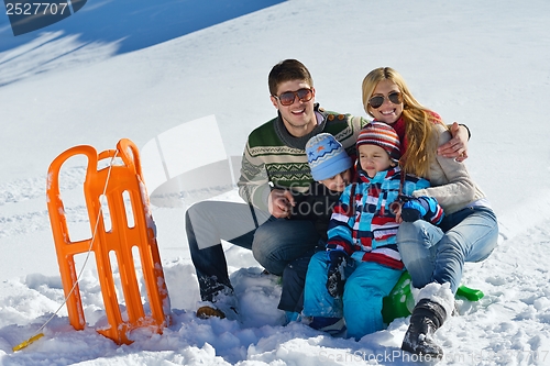 Image of family having fun on fresh snow at winter vacation