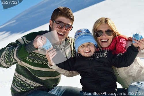 Image of family having fun on fresh snow at winter vacation