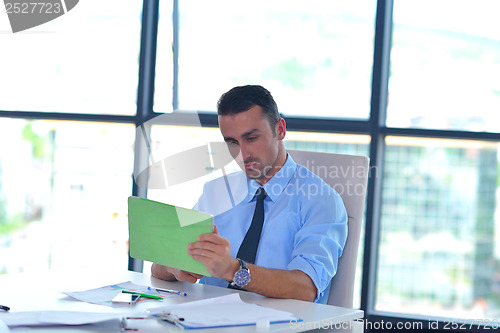 Image of business man using tablet compuer at office