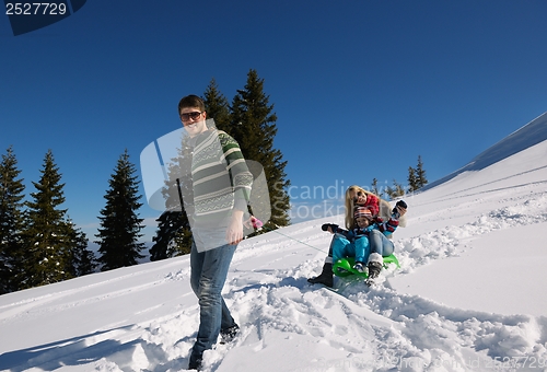 Image of family having fun on fresh snow at winter vacation
