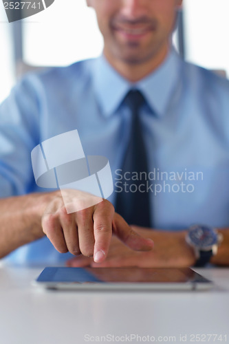 Image of business man using tablet compuer at office