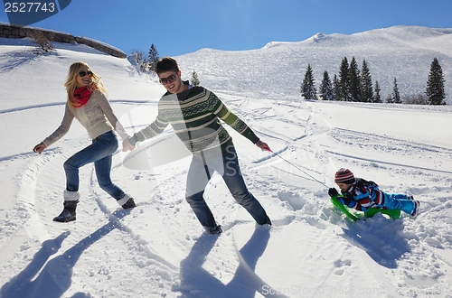 Image of family having fun on fresh snow at winter vacation