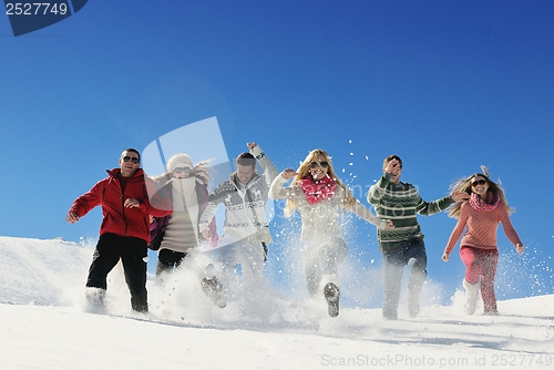 Image of friends have fun at winter on fresh snow