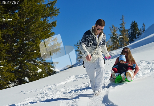 Image of family having fun on fresh snow at winter vacation