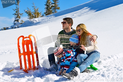 Image of family having fun on fresh snow at winter vacation
