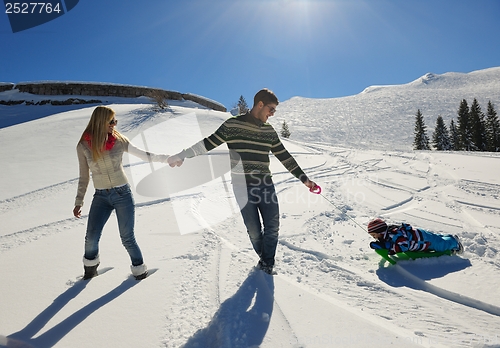 Image of family having fun on fresh snow at winter vacation