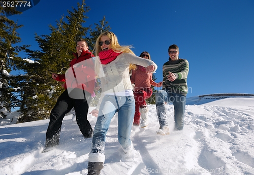 Image of friends have fun at winter on fresh snow