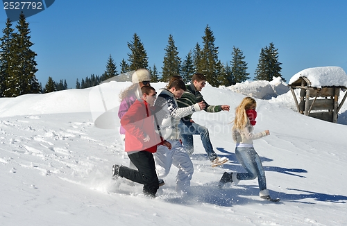 Image of friends have fun at winter on fresh snow