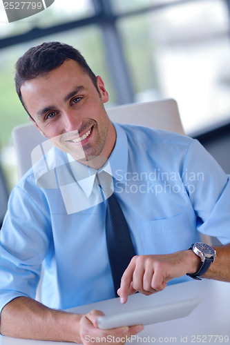 Image of business man using tablet compuer at office