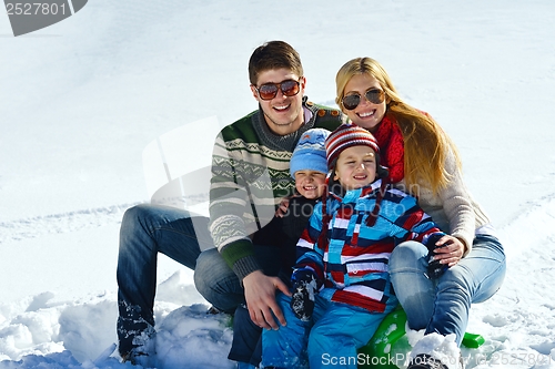 Image of family having fun on fresh snow at winter vacation