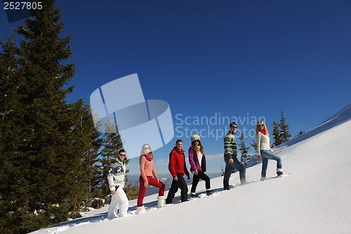 Image of friends have fun at winter on fresh snow