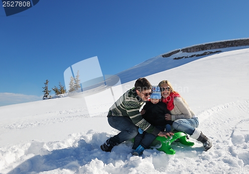 Image of family having fun on fresh snow at winter vacation