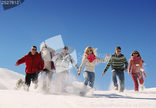 Image of friends have fun at winter on fresh snow